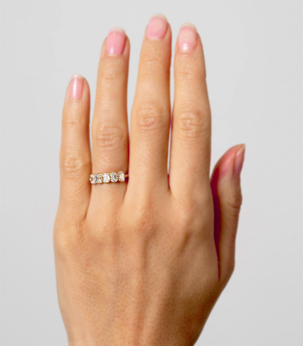 Puro Emerald Cut Band in yellow gold on model.