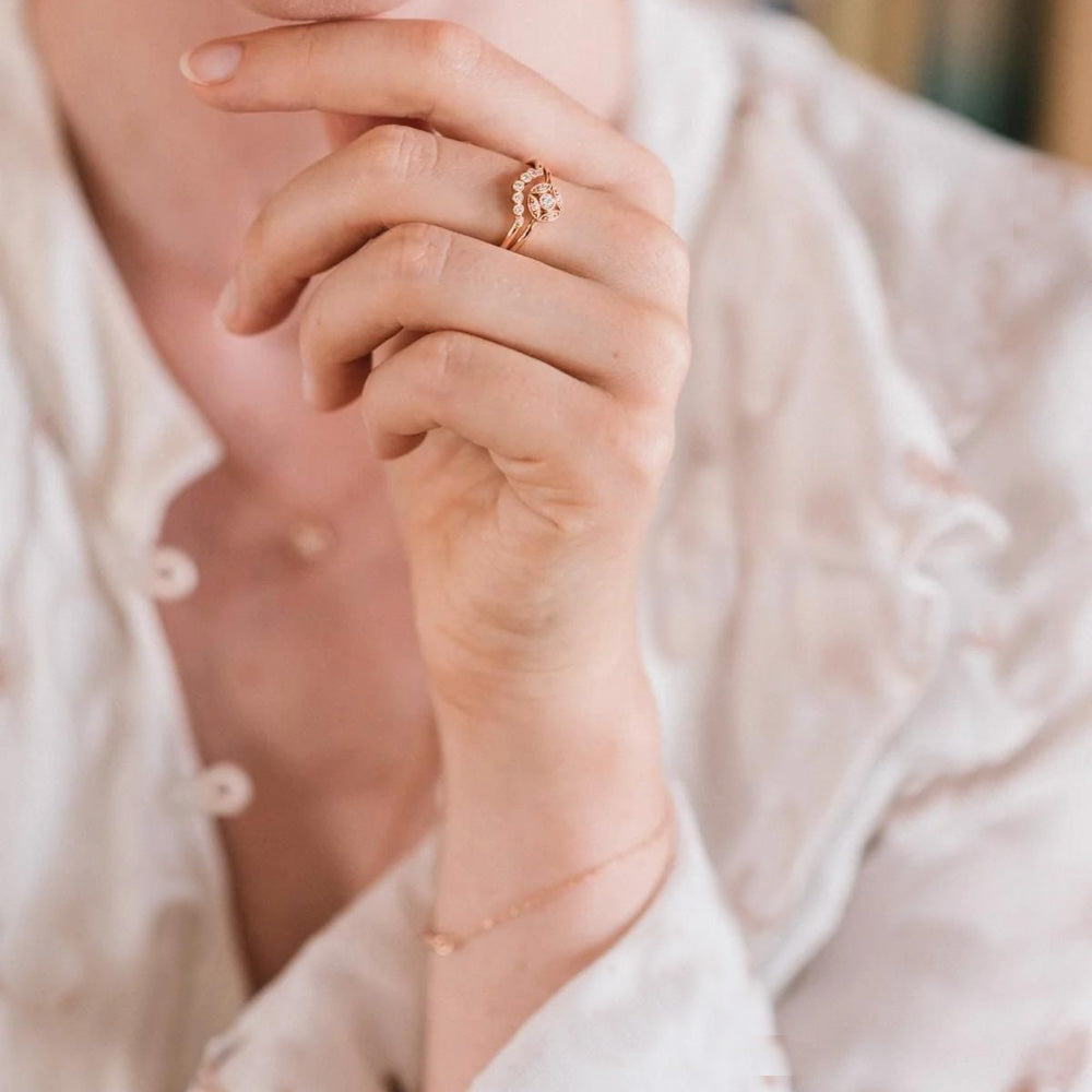 Puro Curved Lunar Diamond Milgrain in rose gold stacked with additional ring on model.
