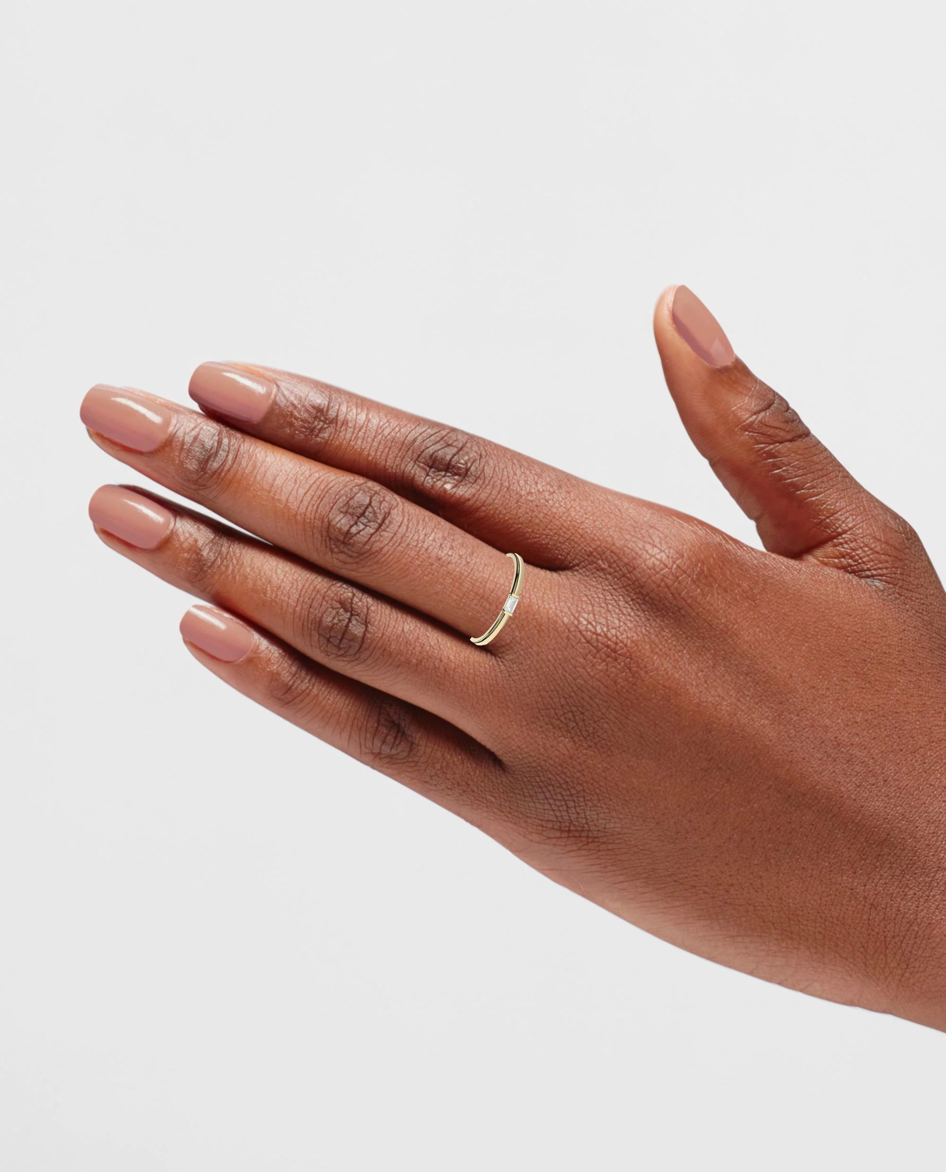 Puro Mini Emerald Cut Diamond Band in yellow gold on model.